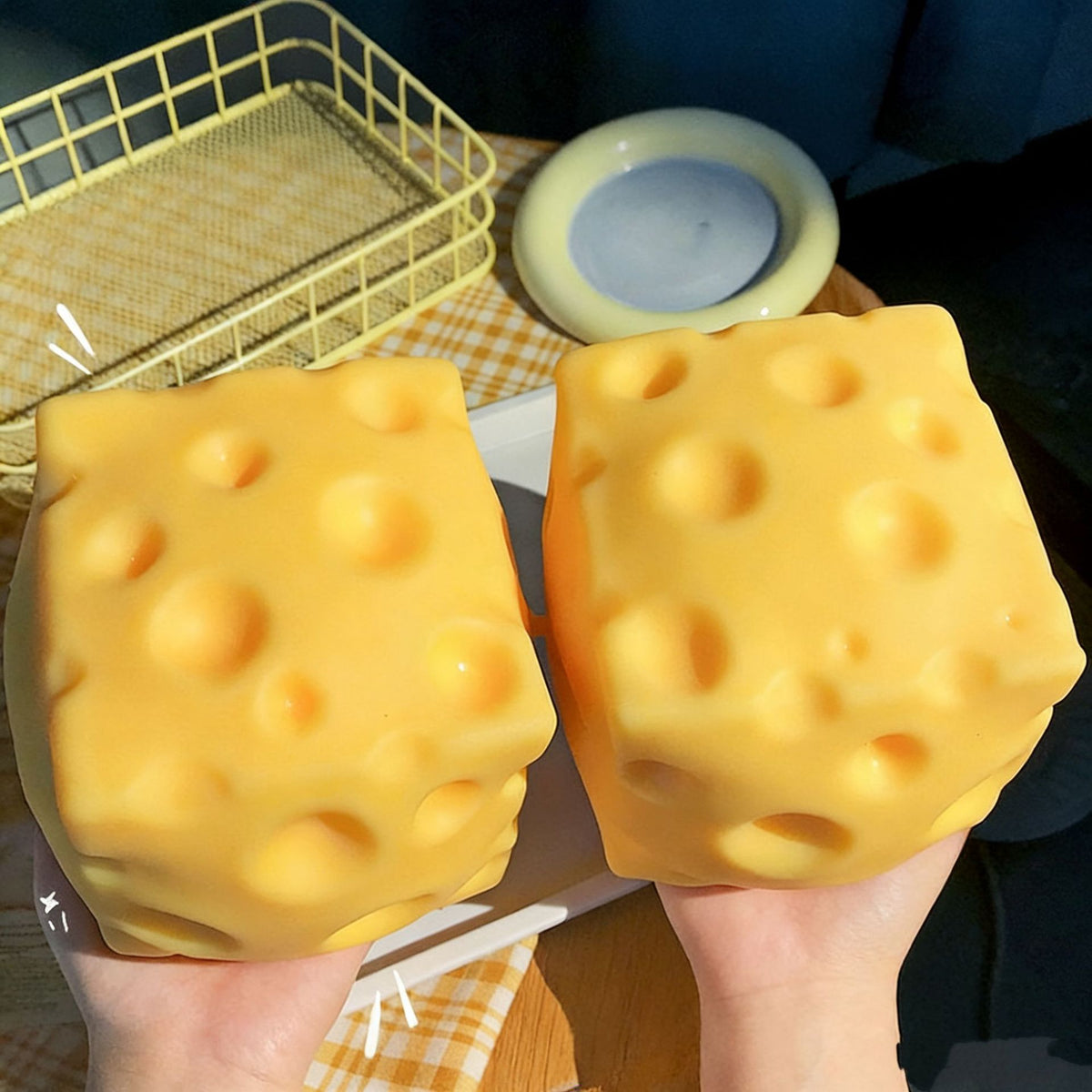 Two cheese block squishies held in hands