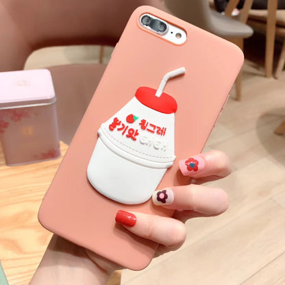 One peach silicone iPhone case with raised white-and-red milk bottle design, straw and Korean text, hand-held.