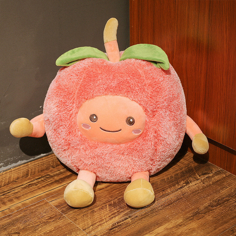 One large round pink plush fruit with a smiling face, four stubby limbs, green leaf and stem.