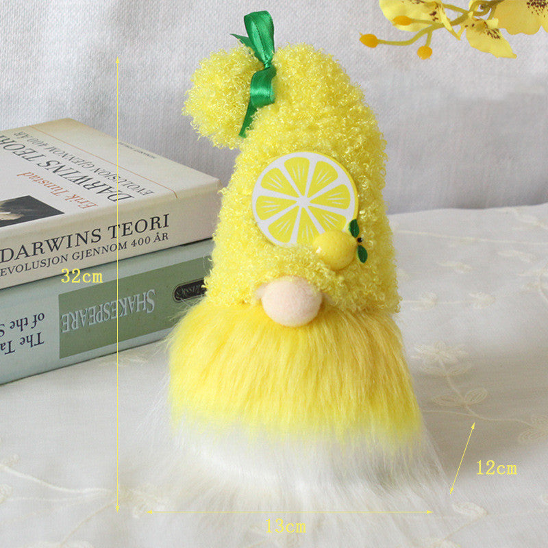 One yellow plush gnome with curly hat, lemon decal, green ribbon, beige nose and yellow-white fur beard, 32cm.