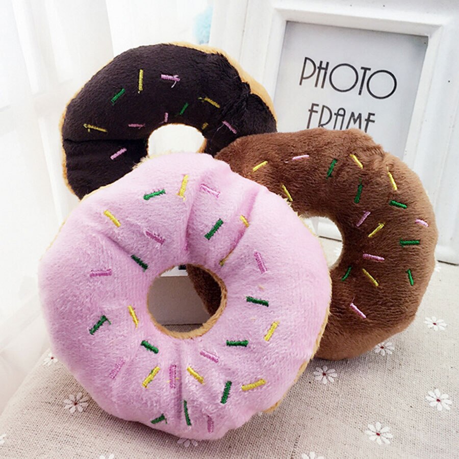 Three plush donut toys (pink, light brown, dark brown) with embroidered multicolor sprinkles are soft.