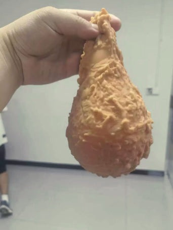 Fried chicken drumstick squishy in a hand