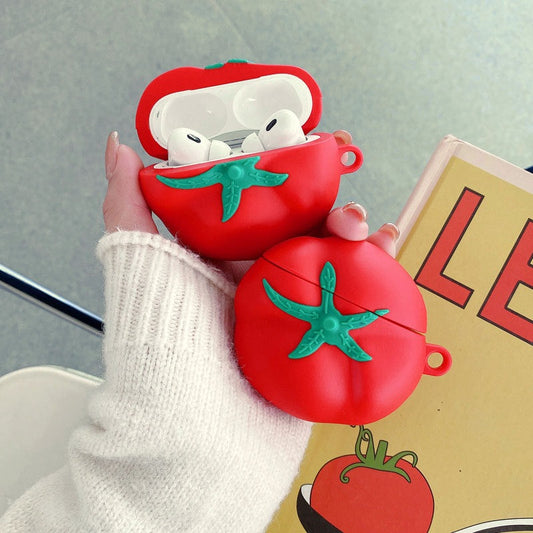 Two tomato AirPods cases held in a hand, one open showing the earbuds
