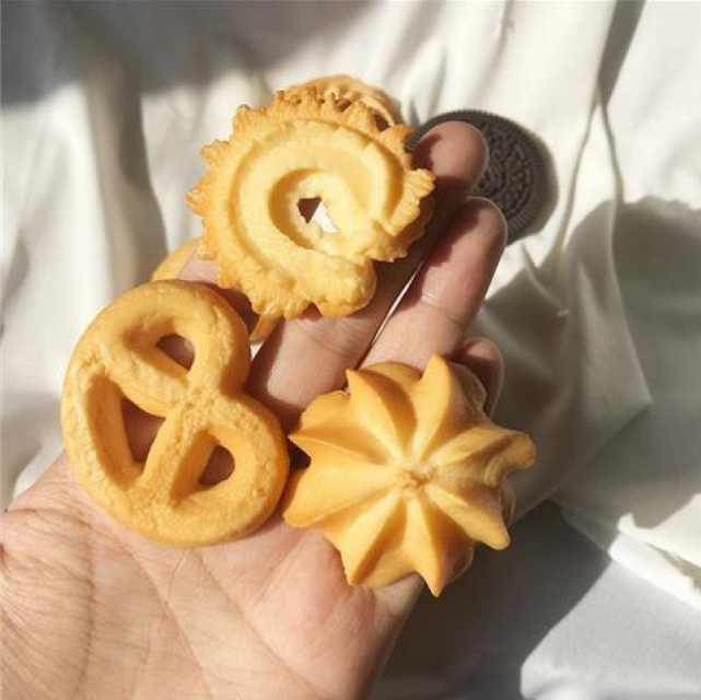Pretzel, ring and flower cookie hair clips in a hand