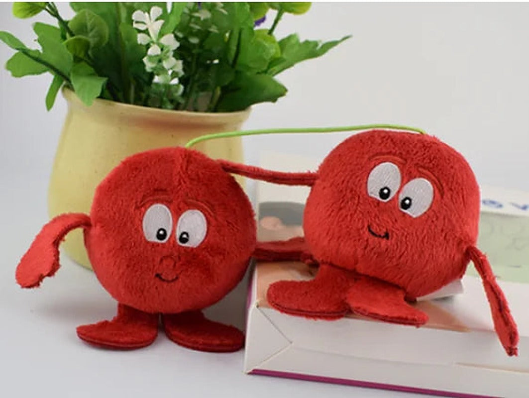 Two red cherry plush toys with smiling faces
