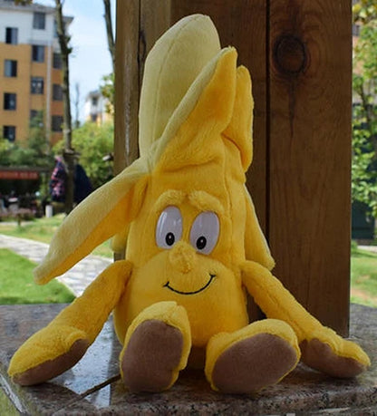 Banana plush with a peeled top, sitting down