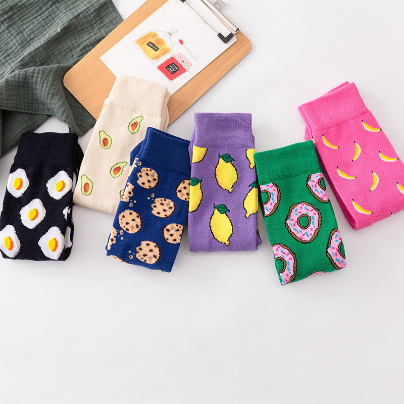 A collection of six food-themed ankle socks featuring designs of eggs, cookies, avocados, lemons, bananas, and donuts.