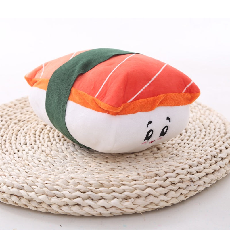 One orange-striped plush with green fabric band and embroidered smiling face on round woven beige mat.