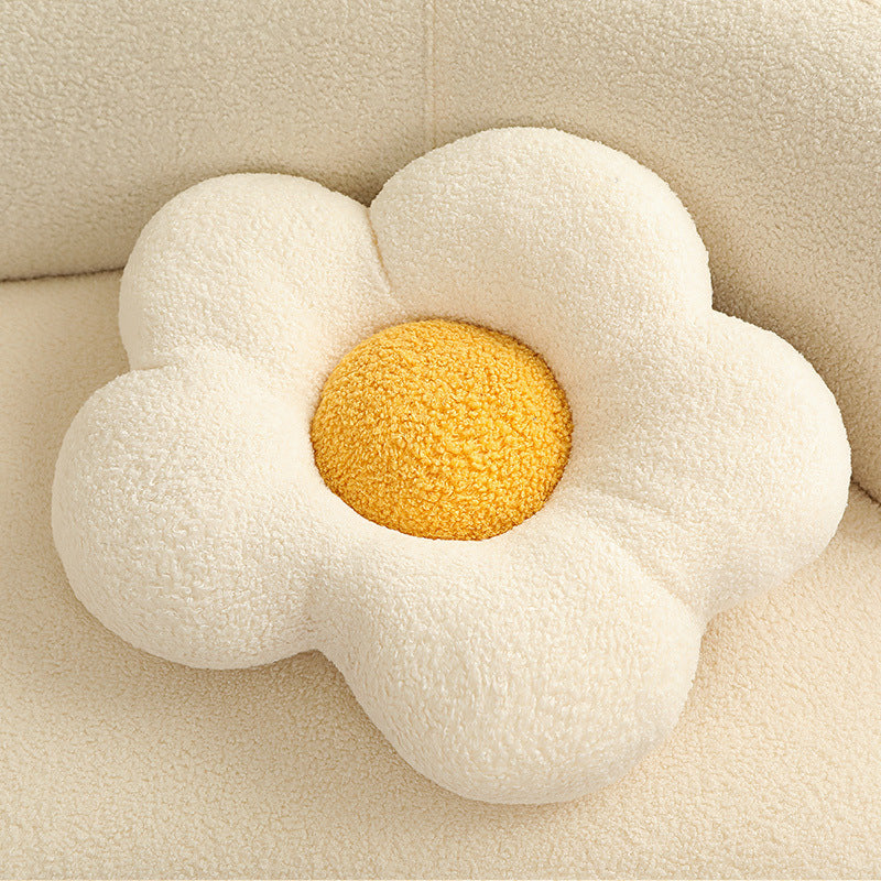 Single cream sherpa flower-shaped cushion with five rounded petals and a textured yellow center.