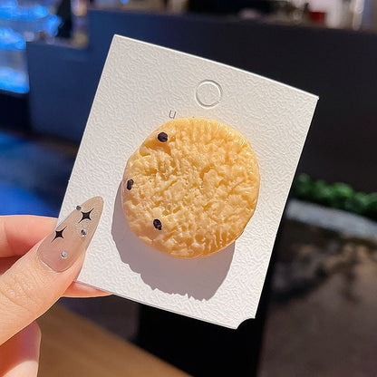 Cranberry cookie hair clip on its backing card