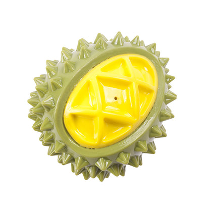 One oval green spiky toy with a glossy yellow segmented center and a small central hole.