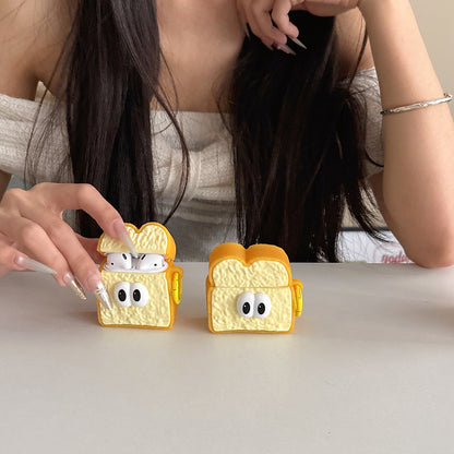 Two toast AirPods cases on a table, one open