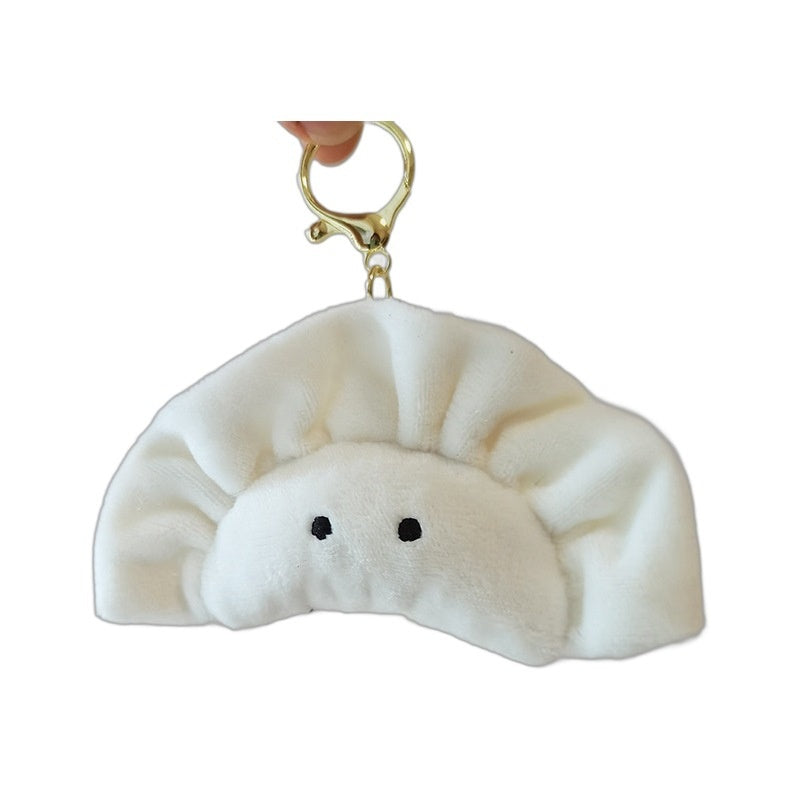 White plush dumpling keychain with a smiley face