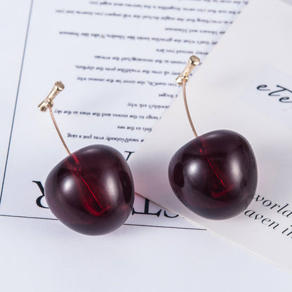Sparkling cherry fruit stud earrings in deep red, featuring a shiny finish and gold-tone accents.