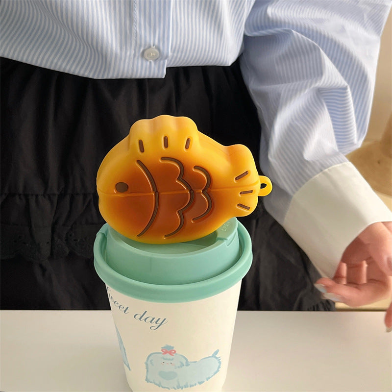 Taiyaki AirPods case resting on a coffee cup