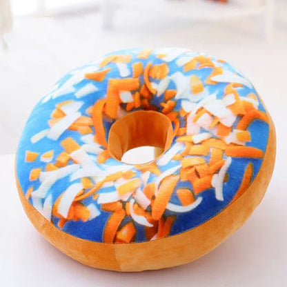 One round plush donut pillow with blue top, white and orange sprinkles, orange side and centre hole.