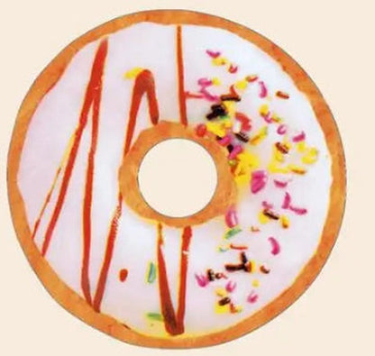 One round donut plush pillow, top view, tan rim with white icing, brown drizzle and multicoloured sprinkles.