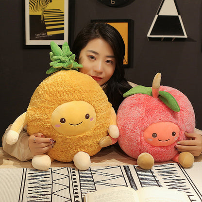 Two large fuzzy fruit plush toys: yellow pineapple with green tuft and pink peach with leaves, both smiling.