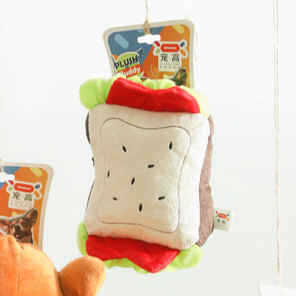 One hanging sandwich plush, beige front with black seed dots, brown sides, red and green trim, attached tag.