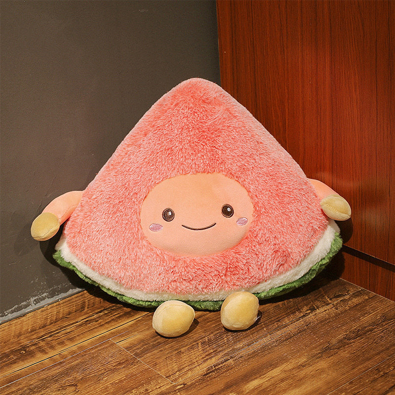 One triangular pink fluffy plush with a smiling round face, small yellow arms and legs, and green-white base.