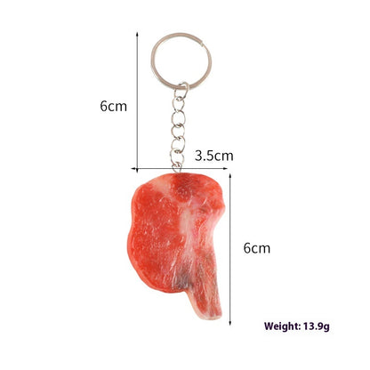 Single keychain with silver ring and chain and red realistic meat-shaped pendant; marked 6cm, 3.5cm, 13.9g.