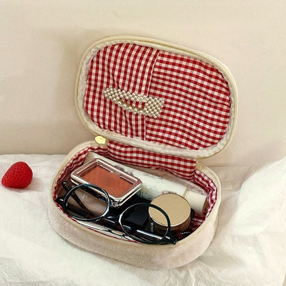 Inside the strawberry sando makeup bag: red gingham lining with a pocket in the lid