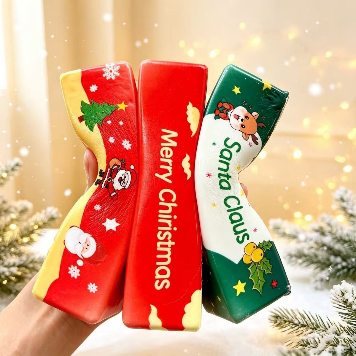 Three Christmas butter stick squishies being squeezed