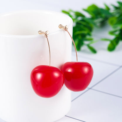 Bright red cherry fruit stud earrings with a shiny finish, hanging elegantly from gold-tone hooks.