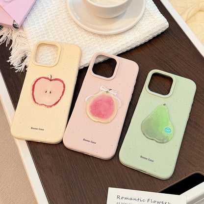 Three 3D fruit silicone iPhone cases in pale pink, green, and cream, featuring apple, pear, and peach designs.