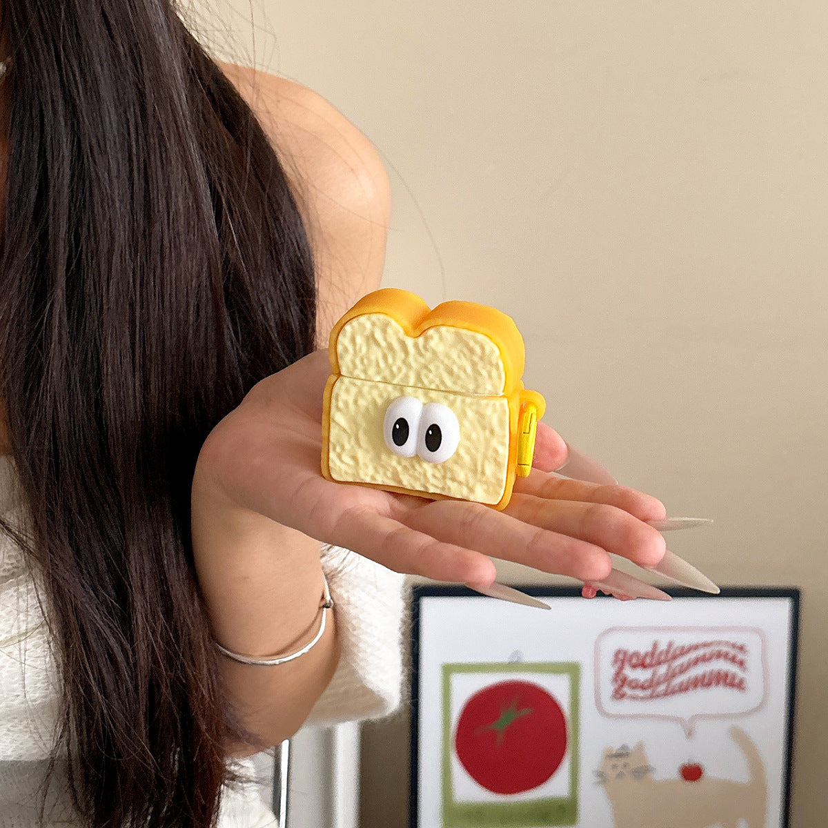 Toast AirPods case held in a hand