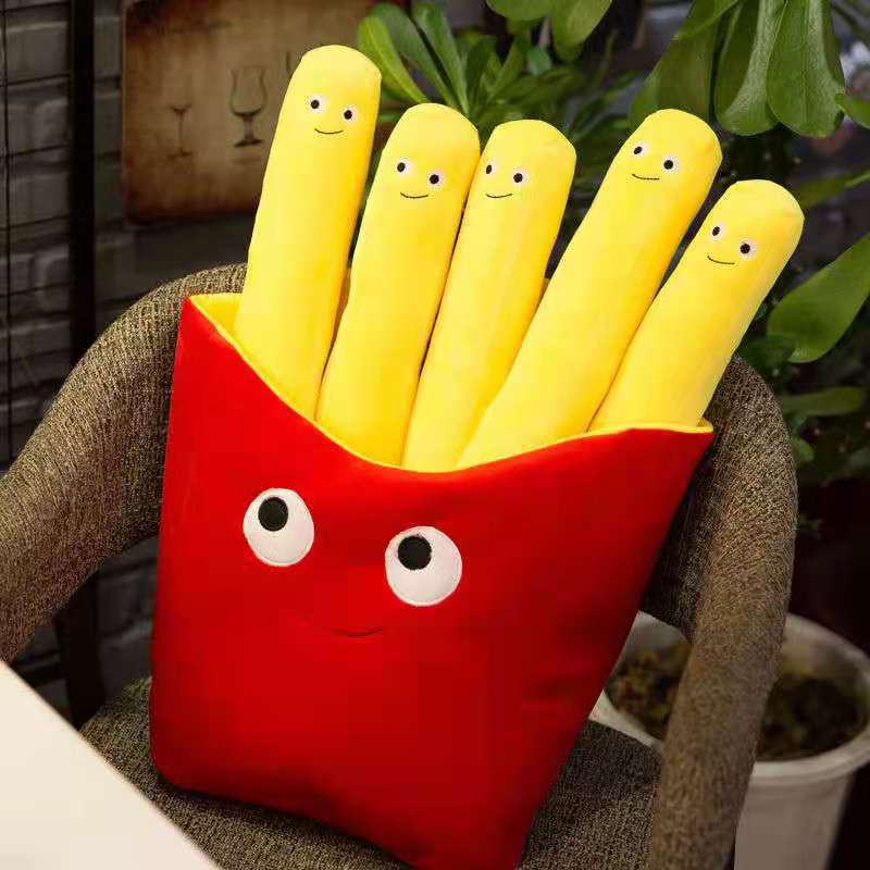 Red plush French-fry container with five long yellow smiling plush fries seated on a gray chair.
