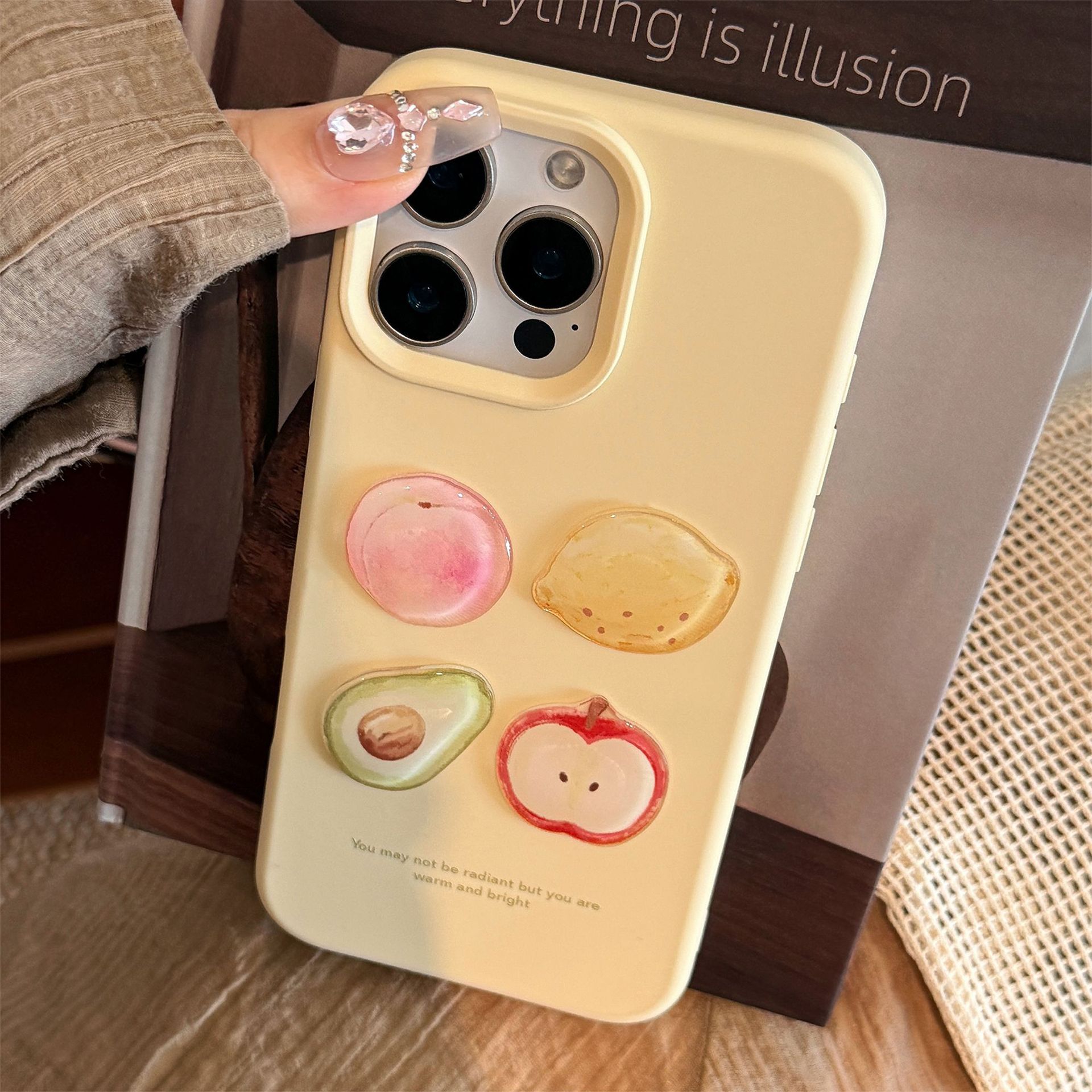 Yellow iPhone case featuring 3D fruit designs: peach, lemon, avocado, and apple, with a glossy finish and cute kawaii style.