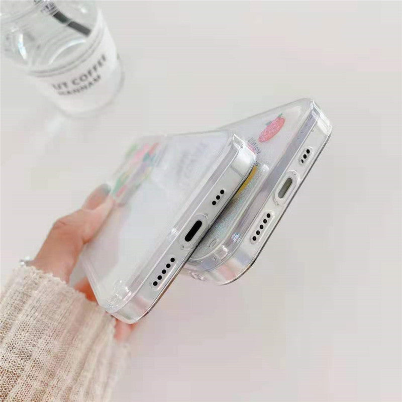 Hand holding two slim clear smartphones with transparent cases stacked, one showing a small strawberry decal.