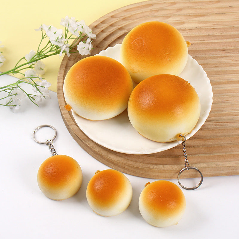 Bun squishy keychains on a plate with flowers