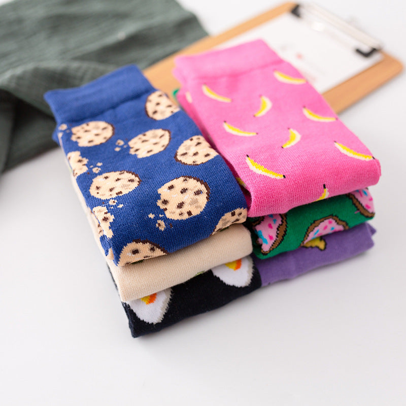 Colourful ankle socks featuring cookie, banana, watermelon, and other food patterns, stacked neatly.