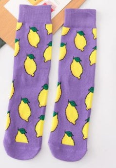 Purple ankle socks adorned with bright yellow lemons and green leaves, perfect for a fun, cosy look.