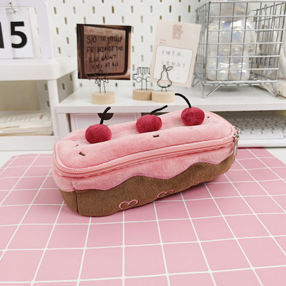 Cherry cake pencil case on a pink desk mat