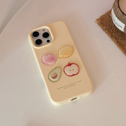 Cream iPhone case featuring 3D fruit designs: peach, avocado, apple, and lemon in vibrant colours.