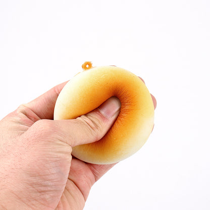 Hand squeezing a golden bun squishy
