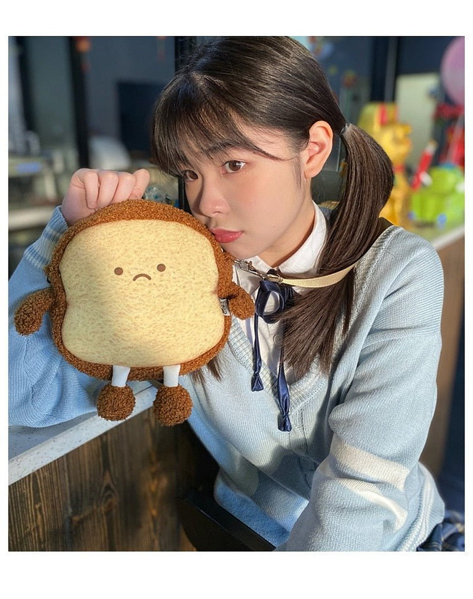 Girl holding the smiling toast bread case up to her cheek