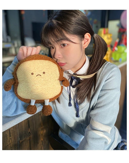 Girl holding the smiling toast bread case up to her cheek
