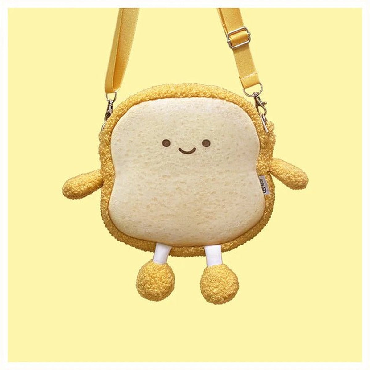 Fluffy smiling toast bread bag with a tan strap on a yellow background