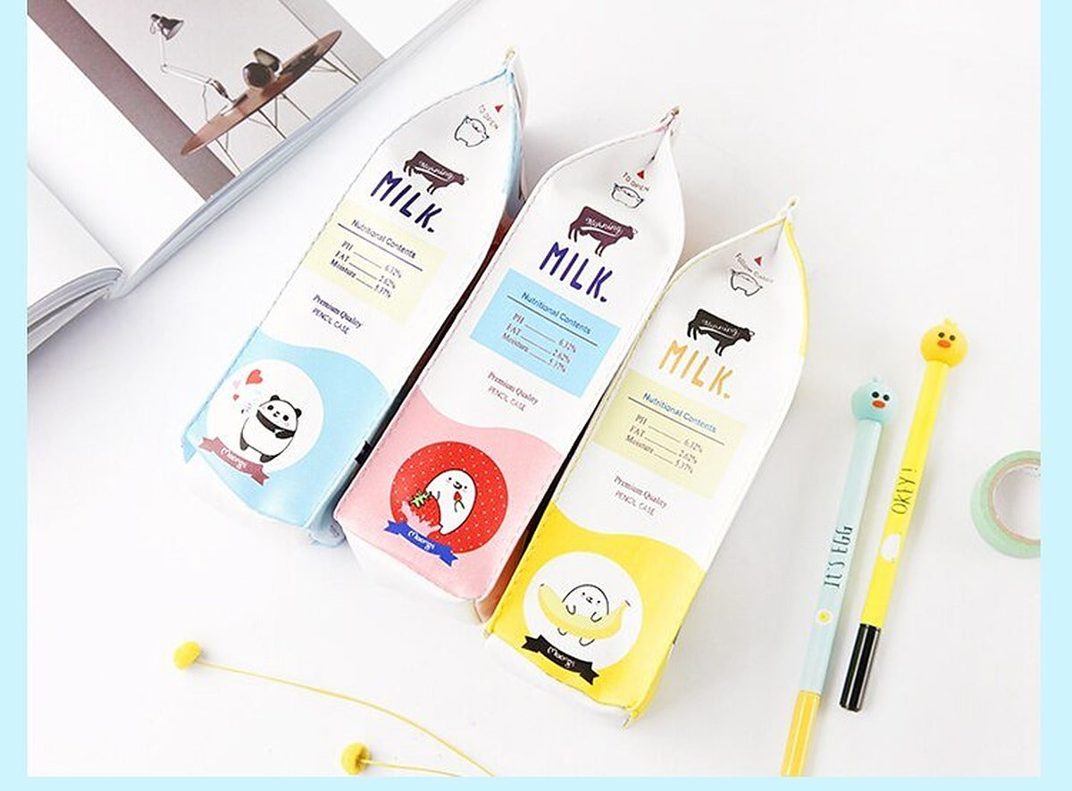 Milk carton pencil cases lying down showing the printed back panels, with gel pens