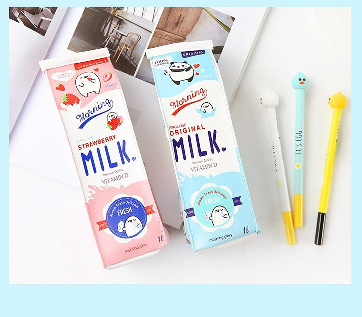 Pink strawberry and blue original milk carton pencil cases standing with gel pens