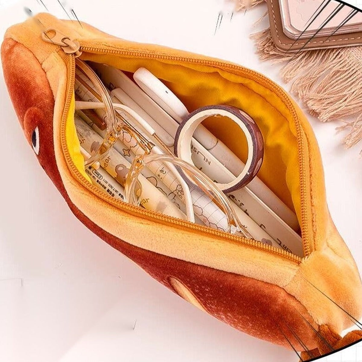 Inside view of the bread plush pencil case open and filled with pens and tape