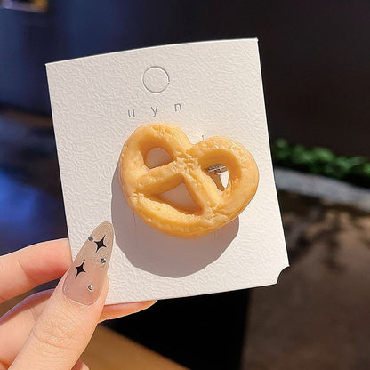 Pretzel cookie hair clip on its backing card