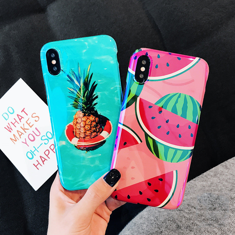 Hand holds two glossy phone cases: turquoise with pineapple on a life ring; pink with watermelon slices.