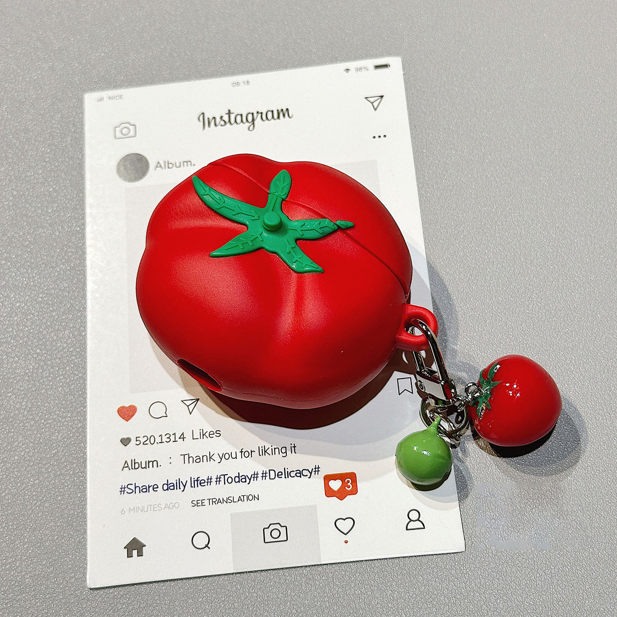 Tomato AirPods case with mini tomato charm