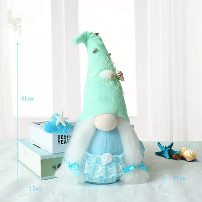 One aqua plush gnome with tall shell-adorned hat (41cm), round beige nose, long white beard, blue lace skirt.