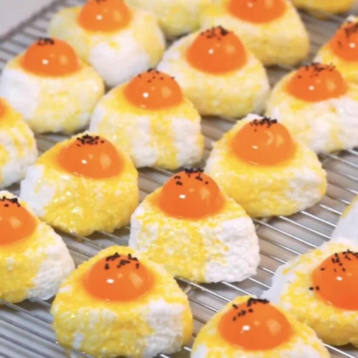 Rows of egg yolk rice ball squishies on a rack